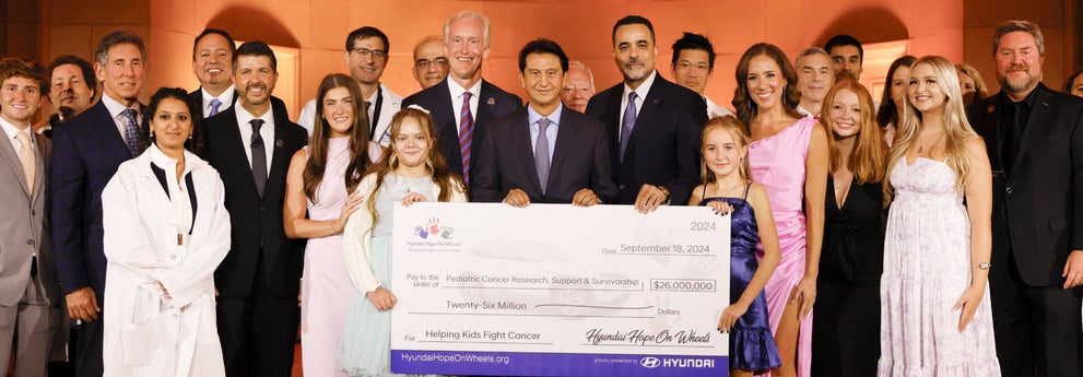 helping kids fight cancer foundation showing their big check from Hyundai hope on wheels - Earnhardt Hyundai in Avondale AZ