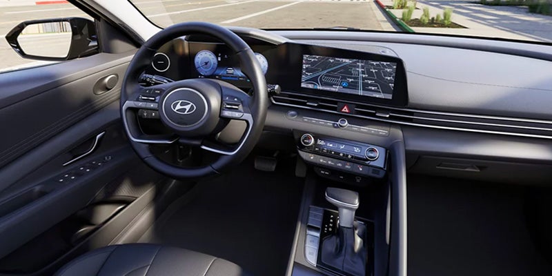 Hyundai Elantra interior showcasing the digital cockpit, steering wheel, and infotainment screen.