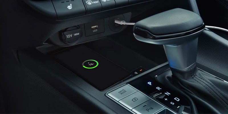 Close-up of a smartphone wireless charging pad in a Hyundai Elantra center console.